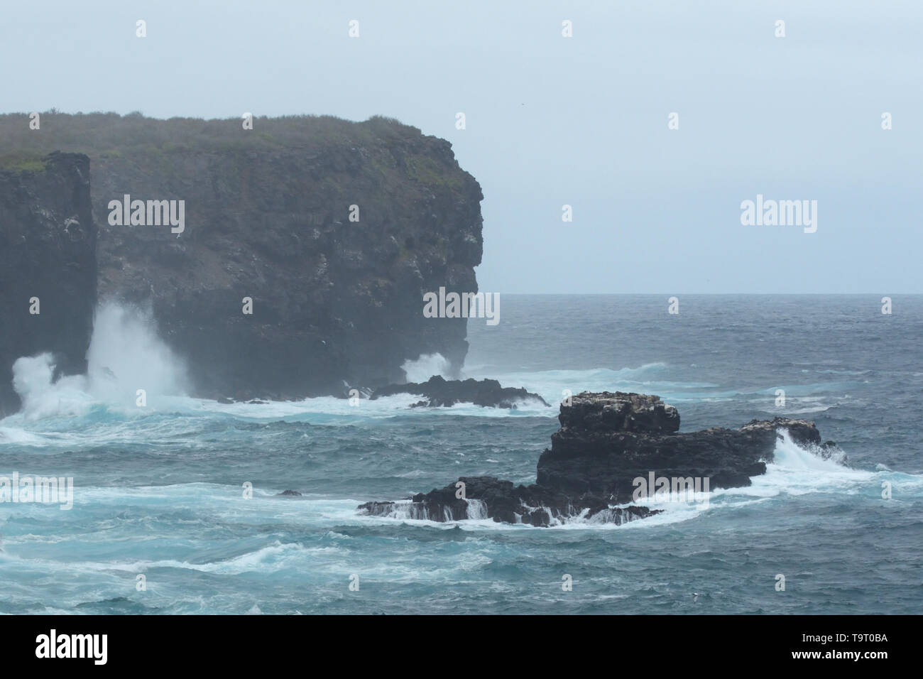 Stormy seas crashing against the cliffs of Espanola Ialand in the Galapagos Islands Stock Photo