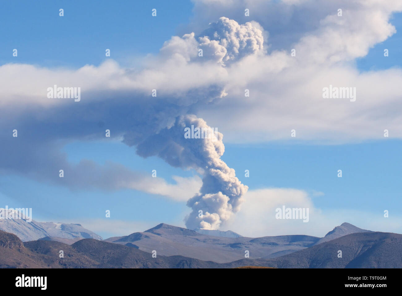 Sabancaya Volcano in the Andes Mountains, column of smoke and ash as it erupts in July 2017 Stock Photo