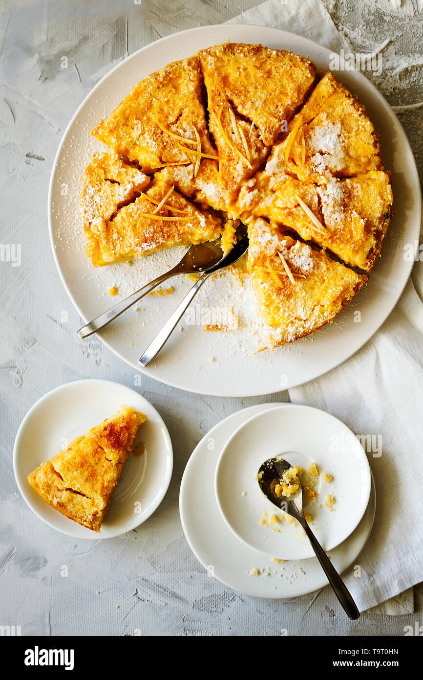 Traditional English lemon pudding cake with lemon twist and powdered