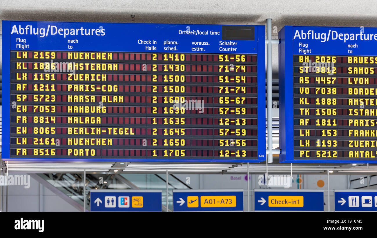 Airport flight information displayed on departure board, flight changing. Flight schedule screen at airport showing different Stock Photo - Alamy