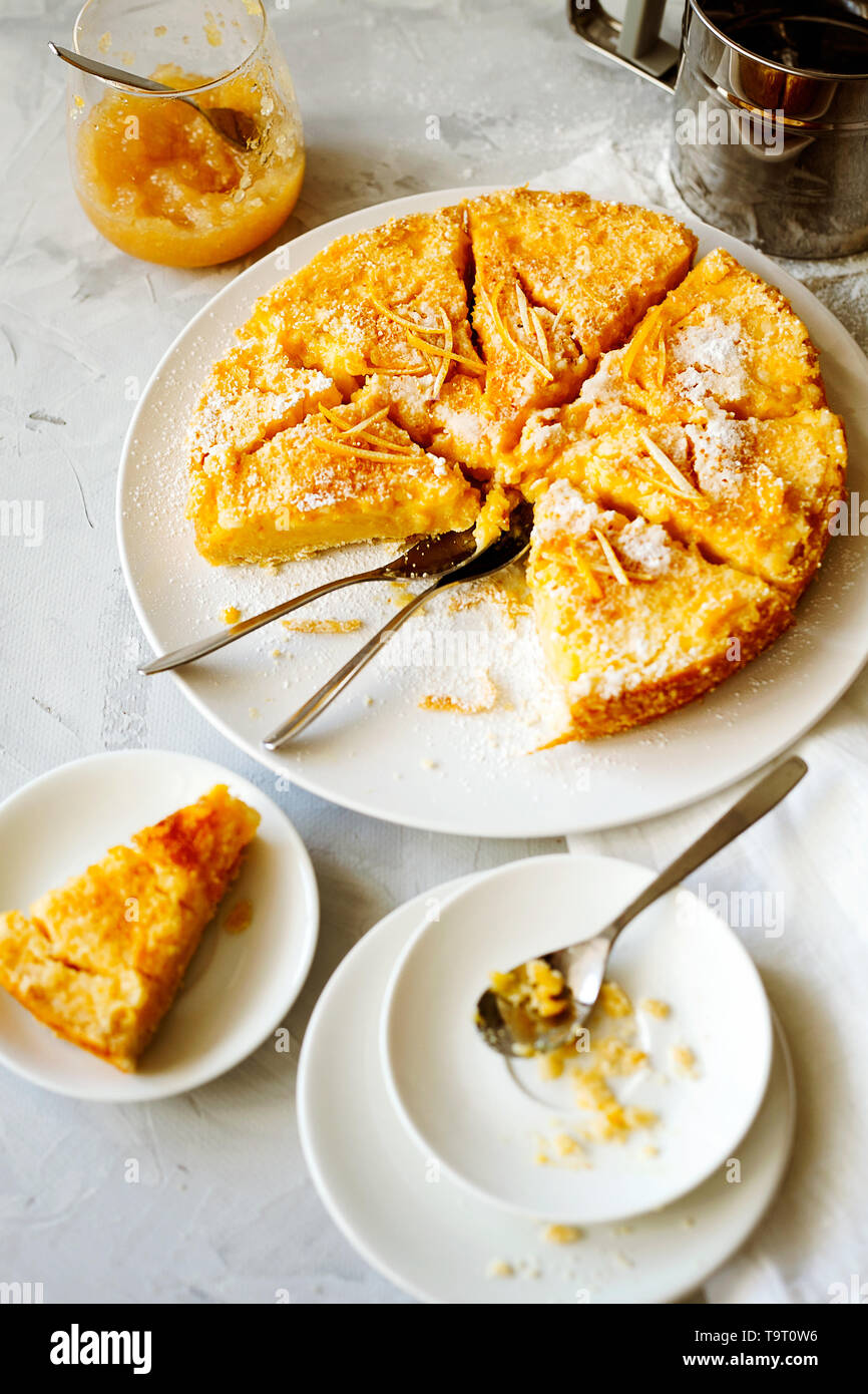Traditional English lemon pudding cake with lemon twist and powdered