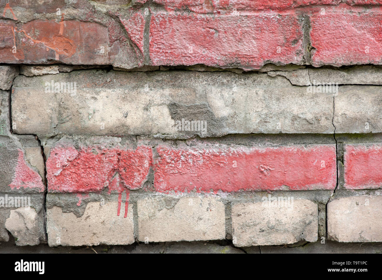 Weathered stained old brick wall for texture or background Stock Photo