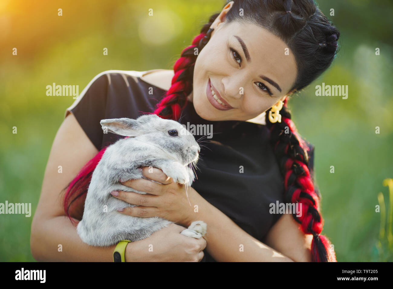 Mature Woman with Red Konekalons Huggs a Rabbit on Nature Stock Photo ...