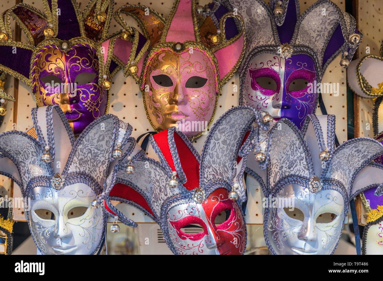 Group of Vintage venetian carnival masks. Venetian masks in store display in Venice. Annual carnival in Venice is among the most famous in Europe. Its Stock Photo