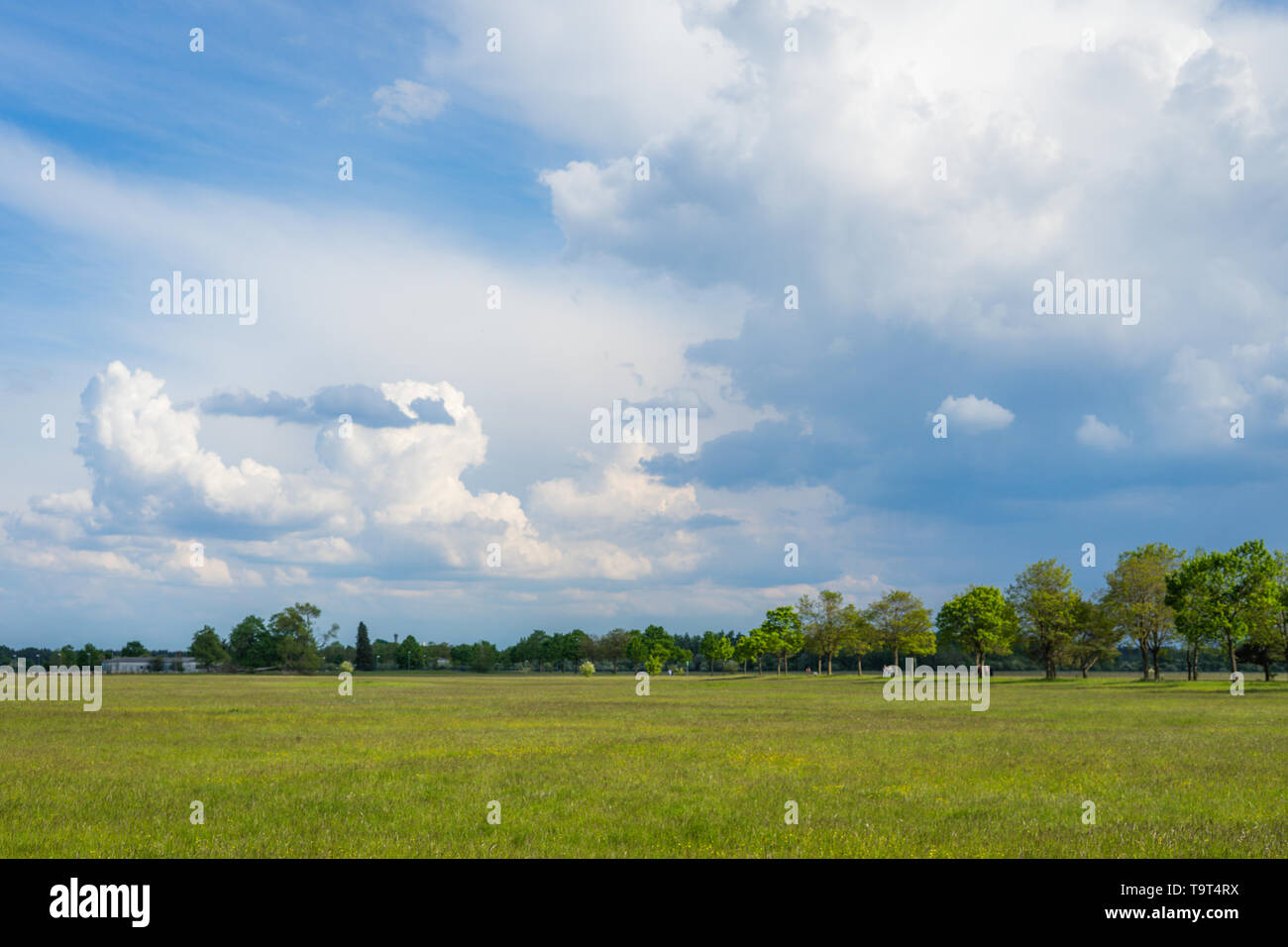 landscape view of a field with cloudy sky Stock Photo