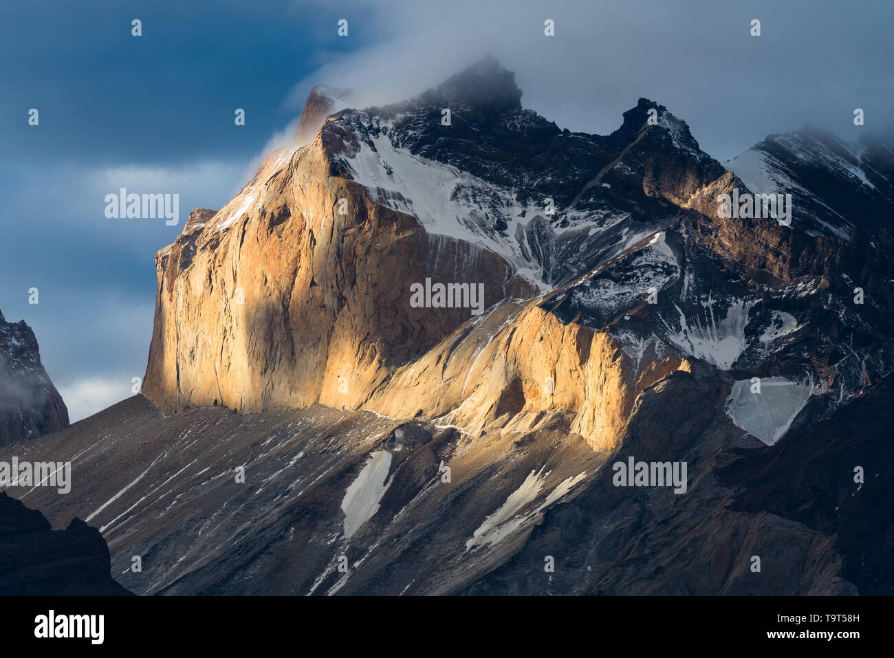 Sunset light illuminates the west face of Monte Almirante Nieto in the Paine Massif in Torres del Paine National Park, a UNESCO World Biosphere Reserv Stock Photo