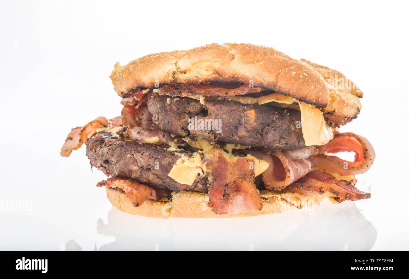 A double burger with cheese and lots of bacon on an isolated background Stock Photo