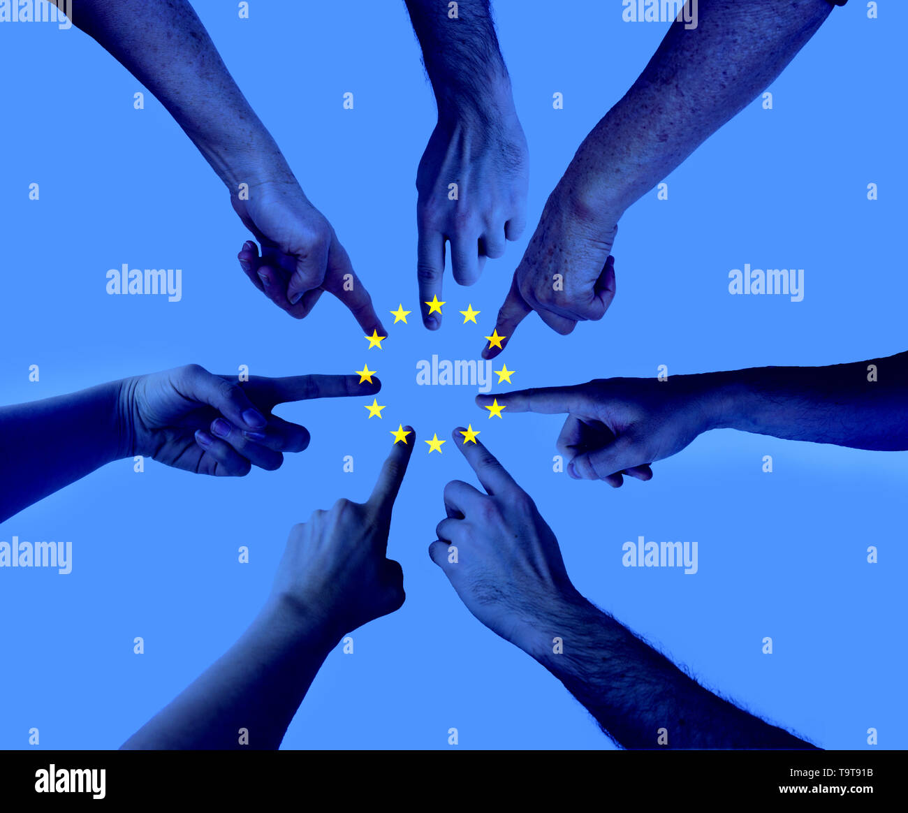 hands pointing on the same spot with an layered european union flag - agreement Elections to the European Parliament concept Stock Photo