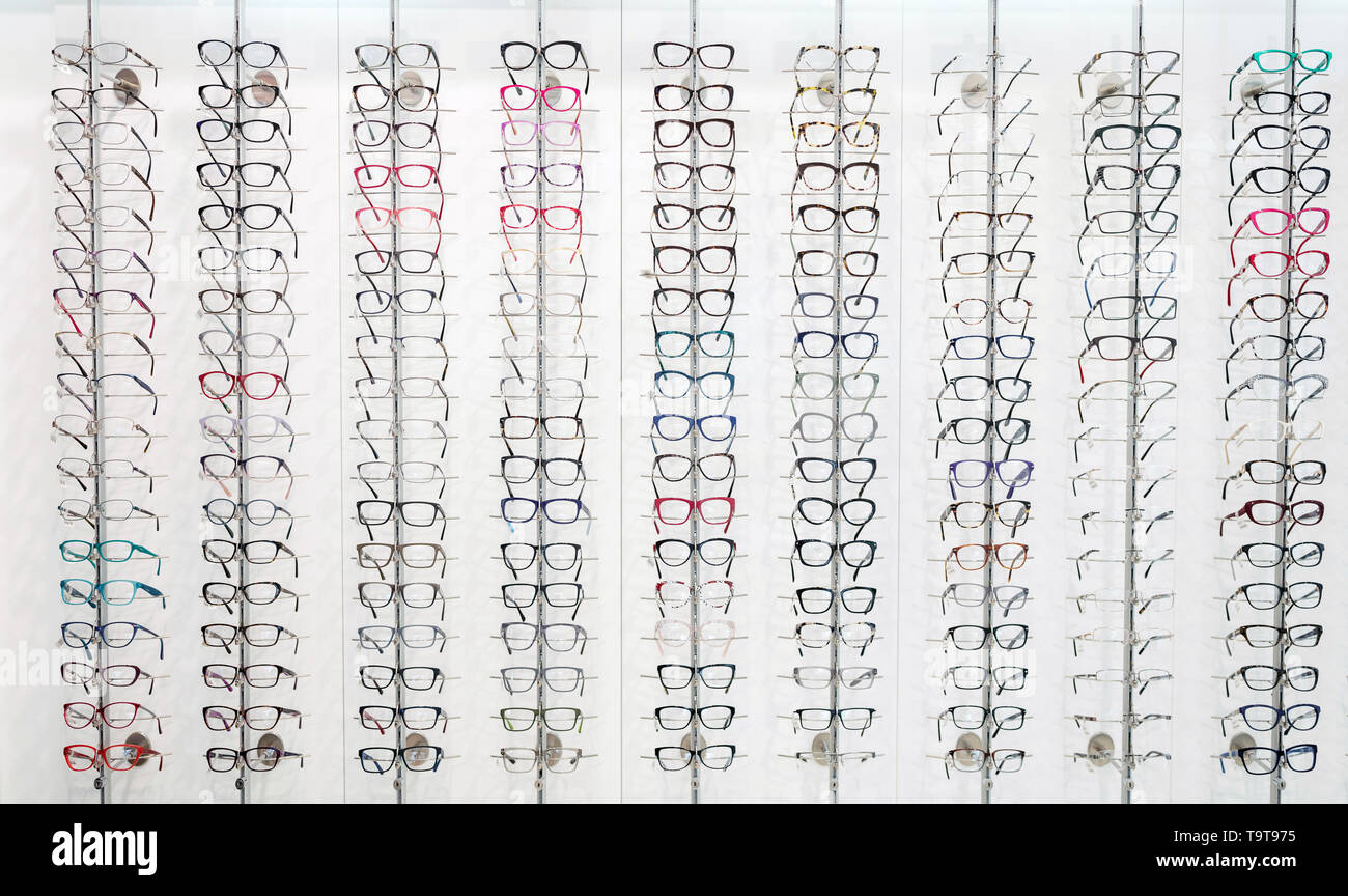 Large selection of eye frames for glasses exposed on panel in eyewear