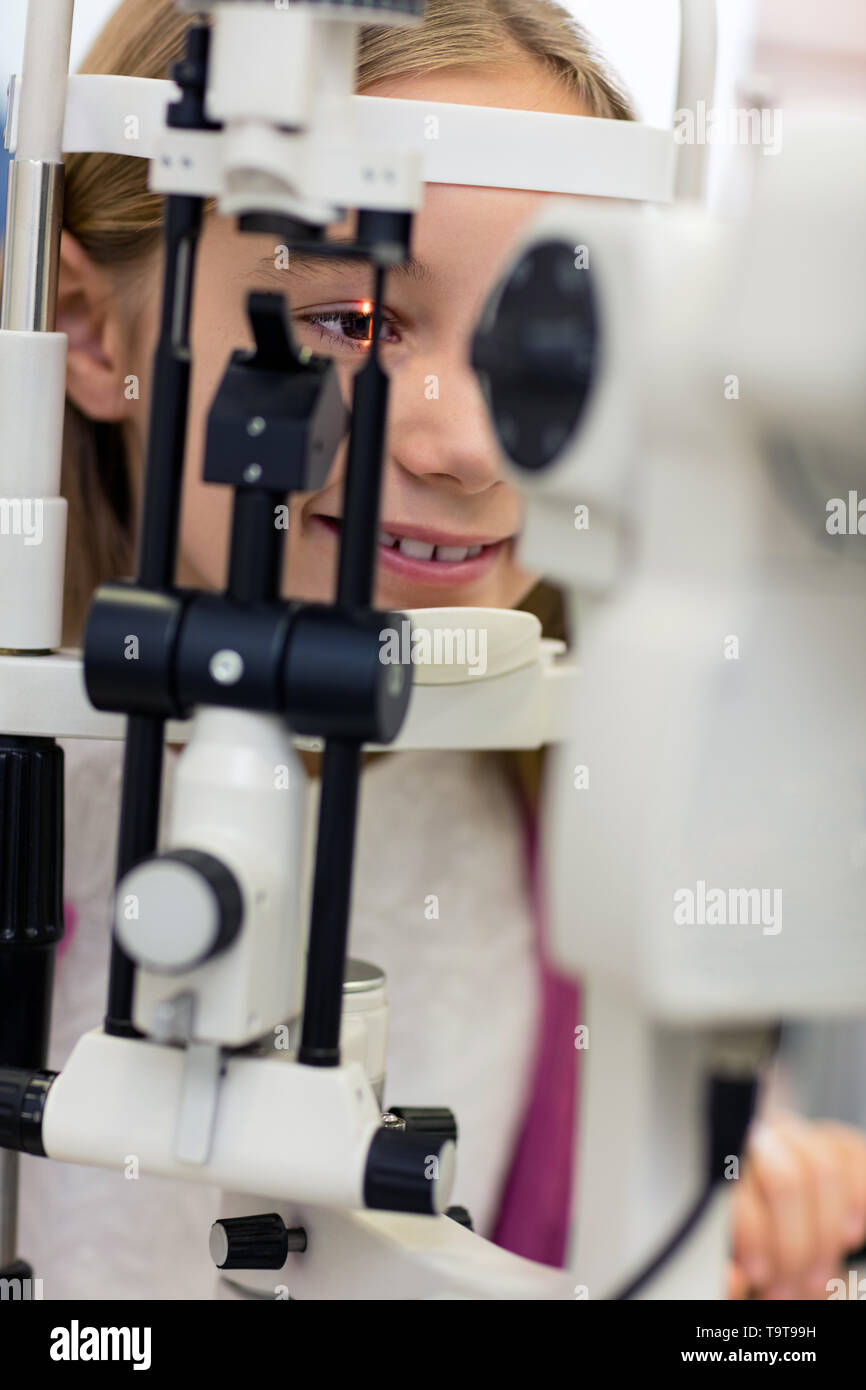 Close up young girl on ophthalmoscope in eye clinic Stock Photo