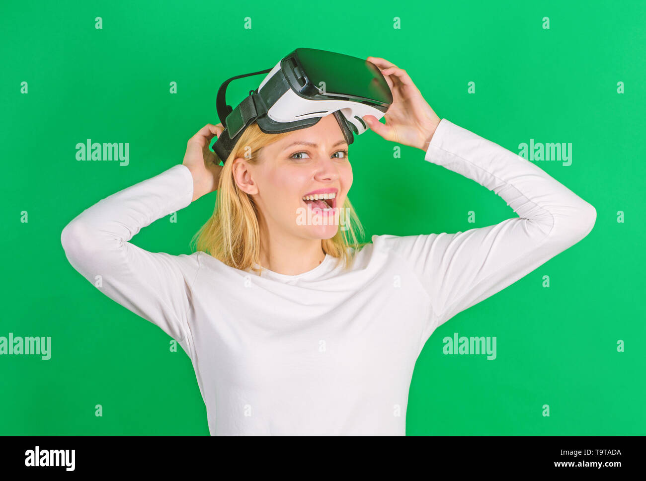 Excited smiling businesswoman wearing virtual reality glasses ...