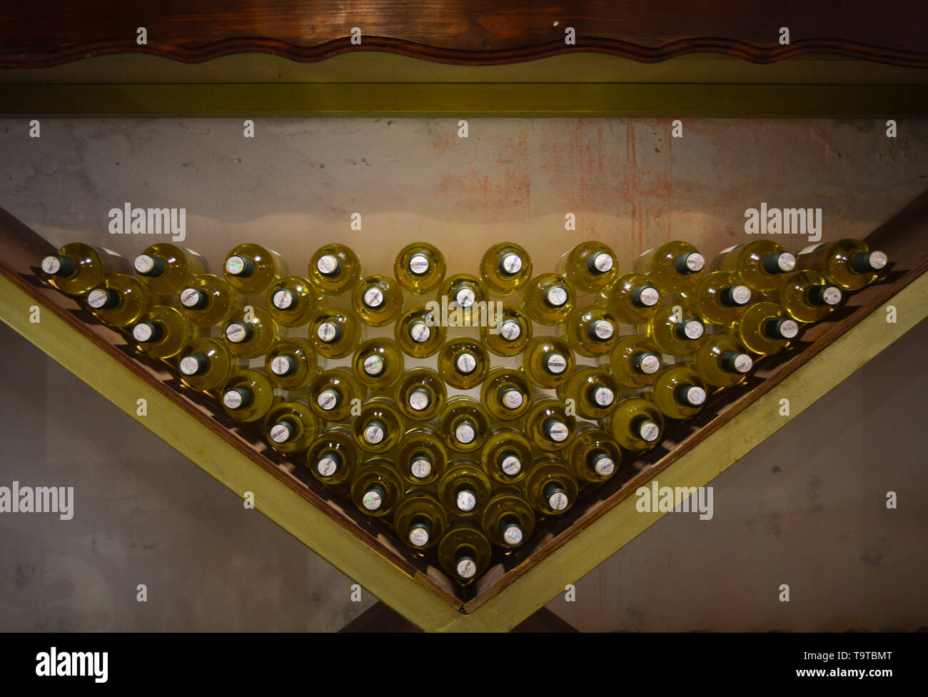 White wine bottles stored in wine cellar Stock Photo Alamy