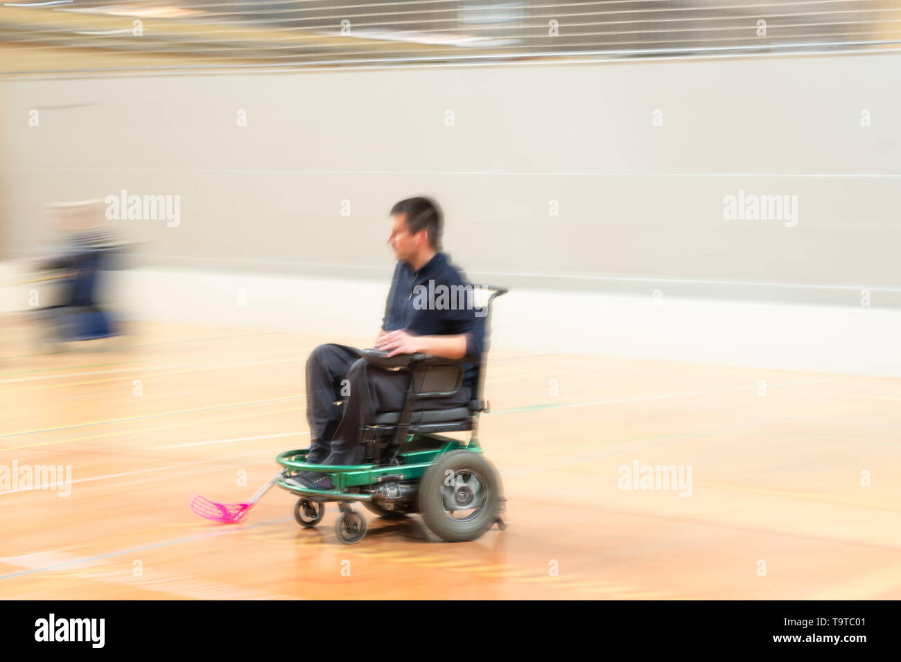 Disabled man in motion on an electric wheelchair playing sports