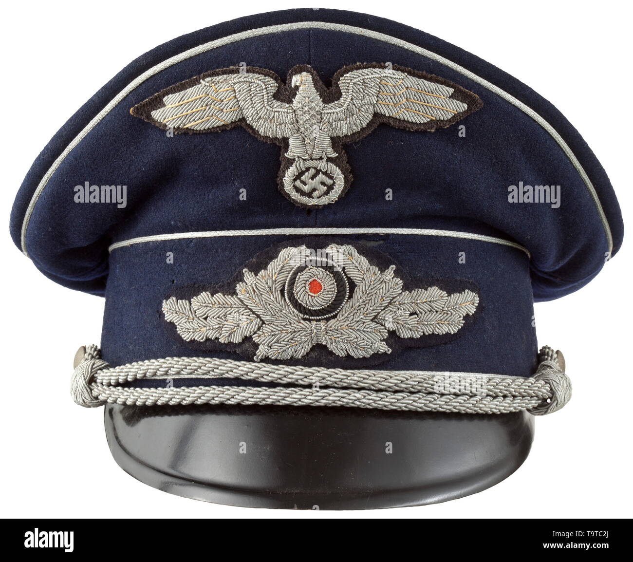 A visor cap to the midnight blue uniform for high-level officials in government service Cap body of fine midnight-blue woollen cloth, trim band of base cloth, silver piping and black-lacquered visor. Cream-coloured silk liner with stitched-in, woven maker's mark 'Benedict Berlin' beneath the cap trapezoid and an inserted name tag of an Oberamtsrichter (tr. high circuit judge) from 1941, brown leather sweatband with silver embossing 'Benedict Berlin', the visor underside in ochre-colour. Moth-traces and signs of usage. Silver-embroidered insignia , Additional-Rights-Clearance-Info-Not-Available Stock Photo