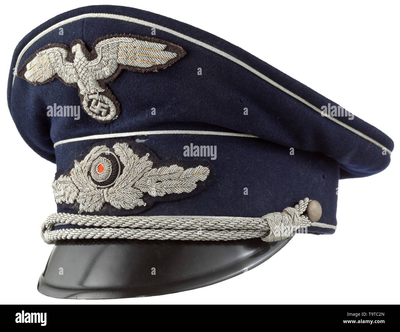 A visor cap to the midnight blue uniform for high-level officials in government service Cap body of fine midnight-blue woollen cloth, trim band of base cloth, silver piping and black-lacquered visor. Cream-coloured silk liner with stitched-in, woven maker's mark 'Benedict Berlin' beneath the cap trapezoid and an inserted name tag of an Oberamtsrichter (tr. high circuit judge) from 1941, brown leather sweatband with silver embossing 'Benedict Berlin', the visor underside in ochre-colour. Moth-traces and signs of usage. Silver-embroidered insignia , Additional-Rights-Clearance-Info-Not-Available Stock Photo