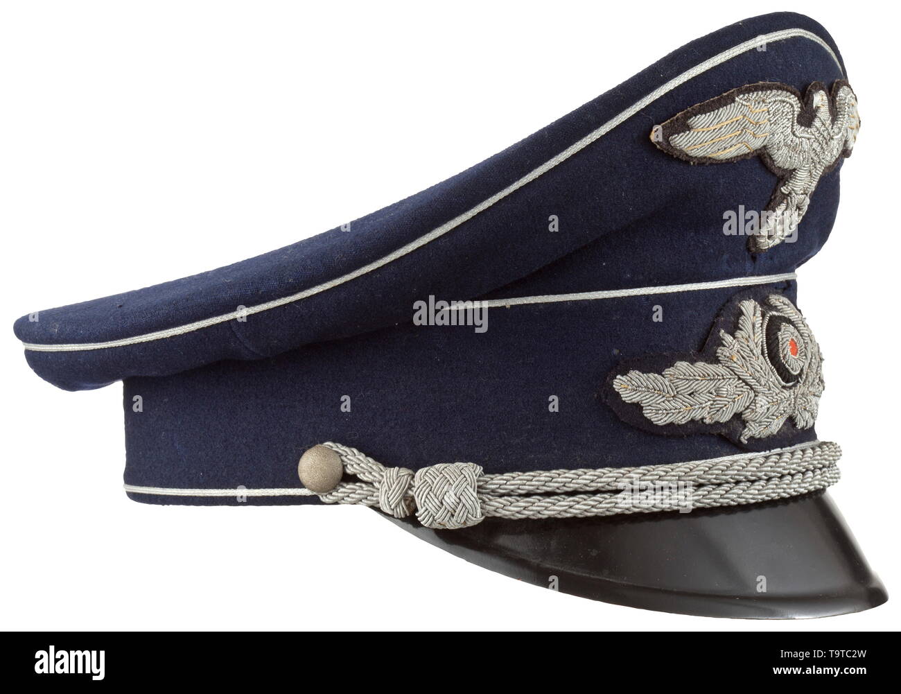 A visor cap to the midnight blue uniform for high-level officials in government service Cap body of fine midnight-blue woollen cloth, trim band of base cloth, silver piping and black-lacquered visor. Cream-coloured silk liner with stitched-in, woven maker's mark 'Benedict Berlin' beneath the cap trapezoid and an inserted name tag of an Oberamtsrichter (tr. high circuit judge) from 1941, brown leather sweatband with silver embossing 'Benedict Berlin', the visor underside in ochre-colour. Moth-traces and signs of usage. Silver-embroidered insignia , Additional-Rights-Clearance-Info-Not-Available Stock Photo
