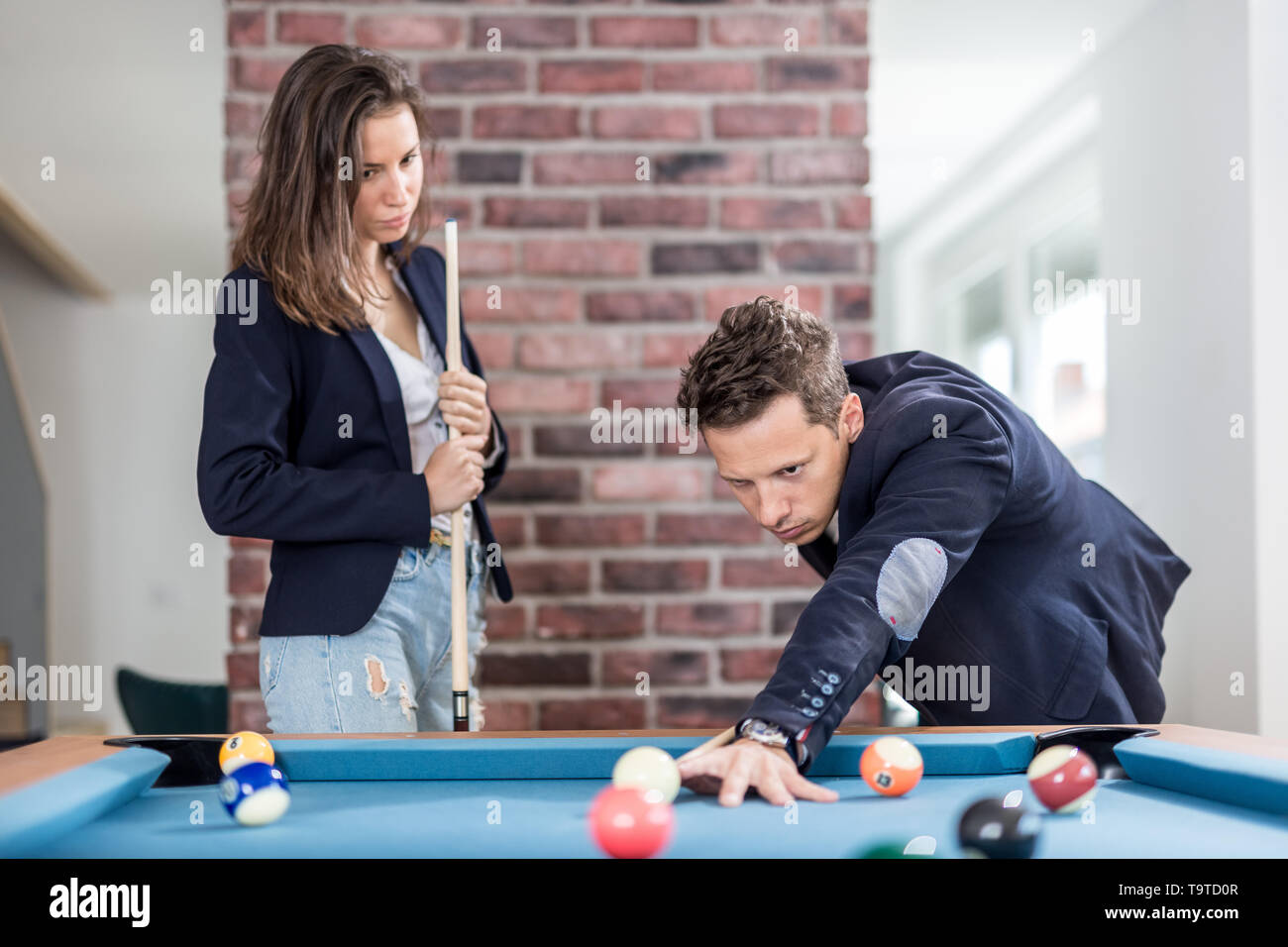 Fashionable couple playing snooker. Stock Photo