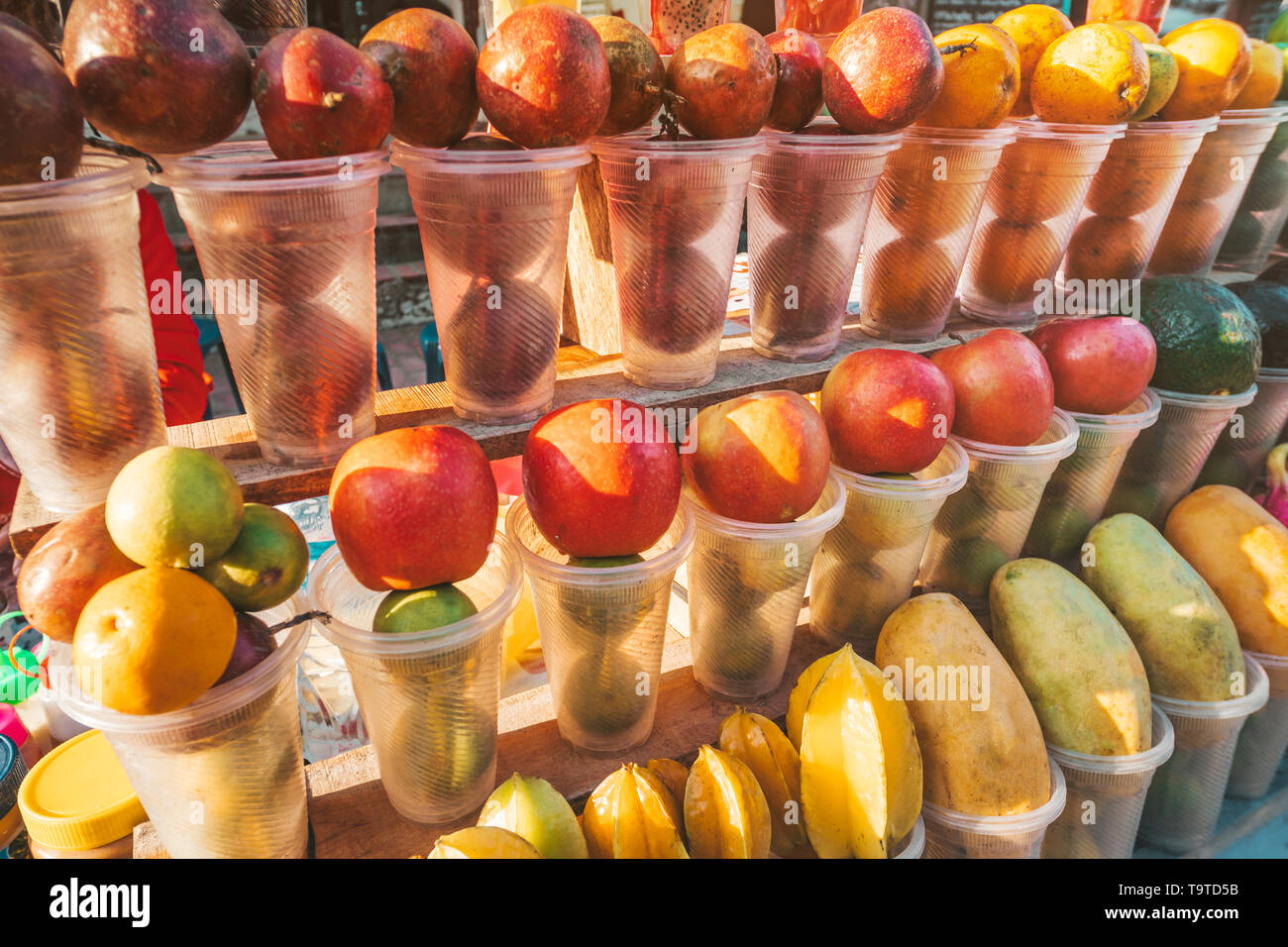 Fruits in plastic cups, ready to be made into fresh fruit shakes at