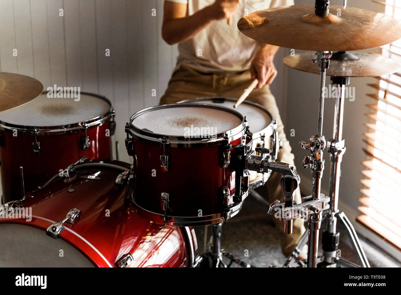 Drummer practicing rudiments on his home drum kit Stock Photo Alamy