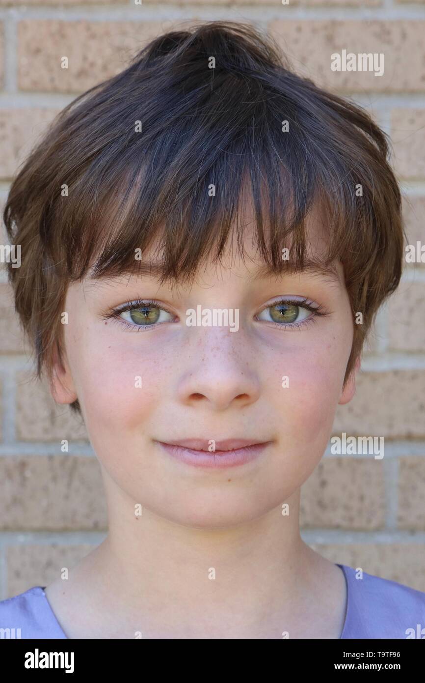 Portrait of a child with a brown pixie cut and big hazel eyes Stock Photo