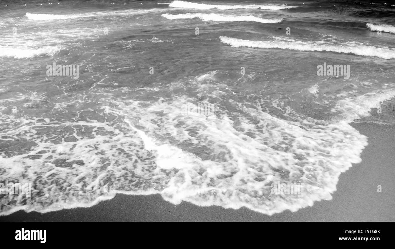 Black and white image of sea waves rolling on the sandy shore Stock ...