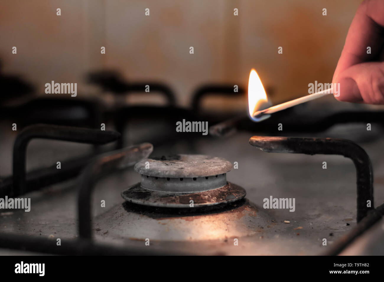Dirty gas hob being lit with a match Stock Photo Alamy