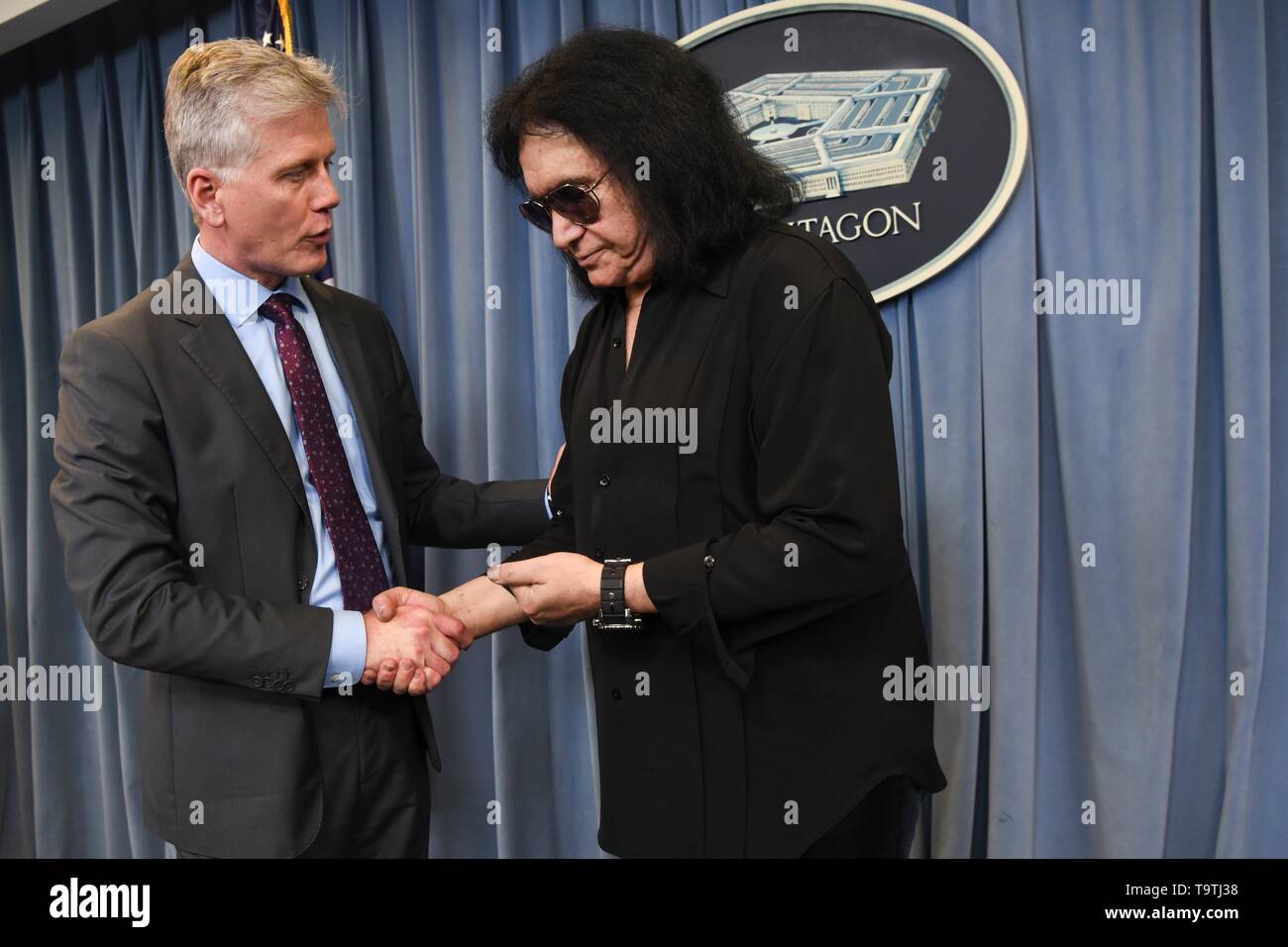 U.S. Assistant to the Secretary of Defense for Public Affairs Charles E. Summers Jr. left, shakes hands with rock legend Gene Simmons of KISS during a meet-and-greet at the Pentagon May 16, 2019 in Washington, D.C. Stock Photo