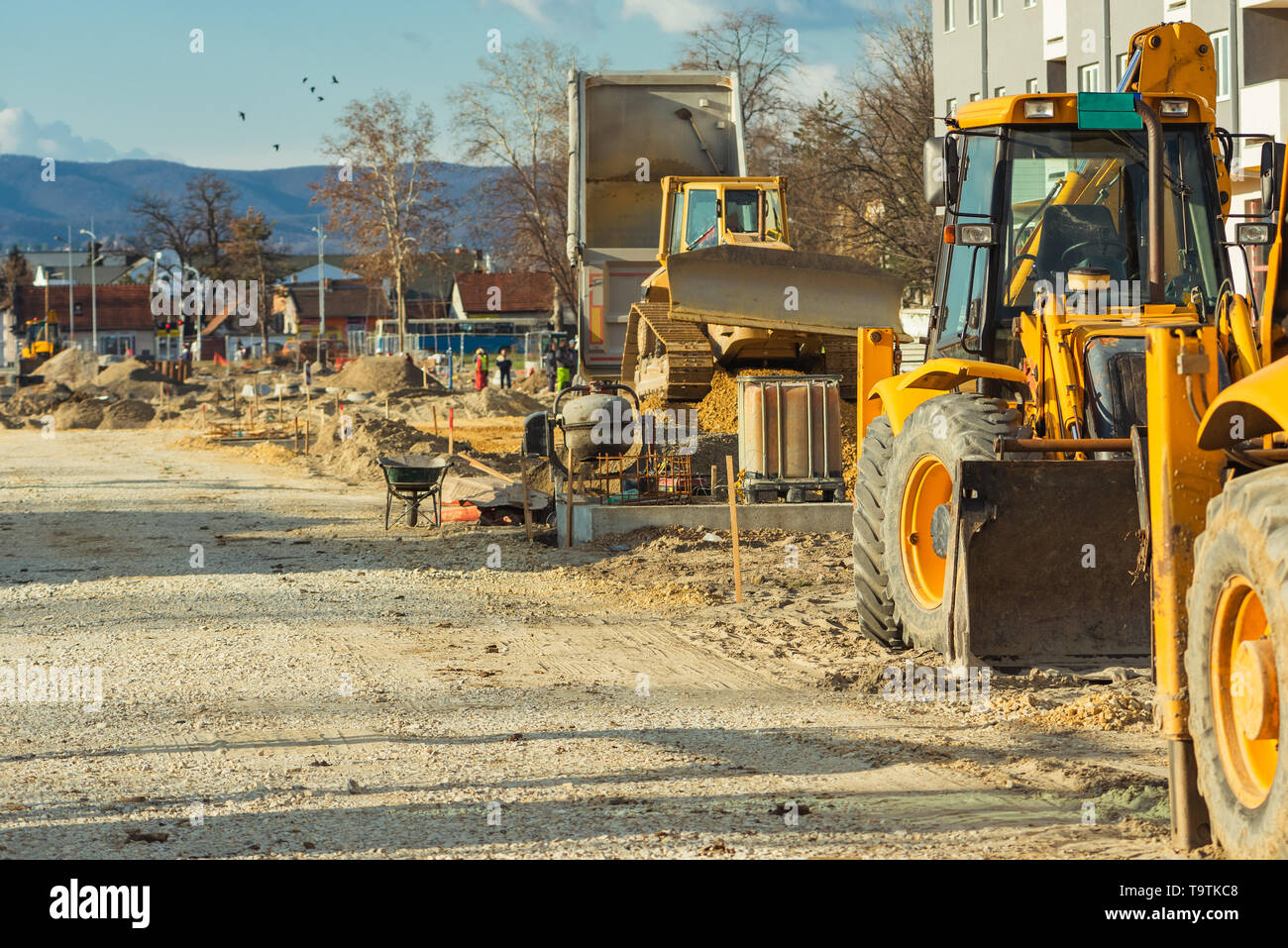 Construction vehicle with loader on building site, industrial heavy machinery Stock Photo