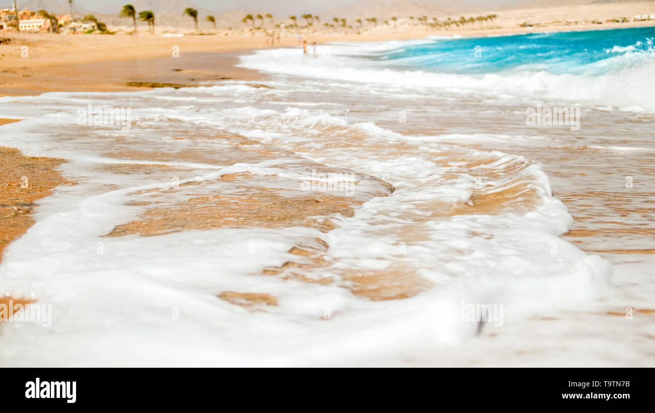 Closeup image of sea waves rolling on the sandy sea beach Stock Photo ...