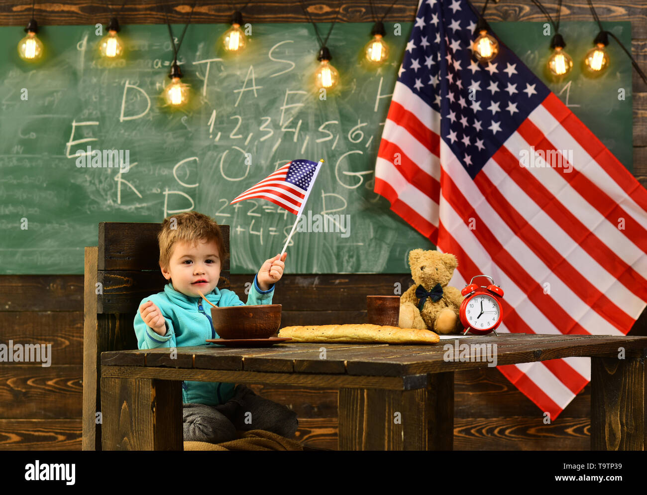 Student girl kid at USA flag. Child on the background with flag of the USA Stock Photo