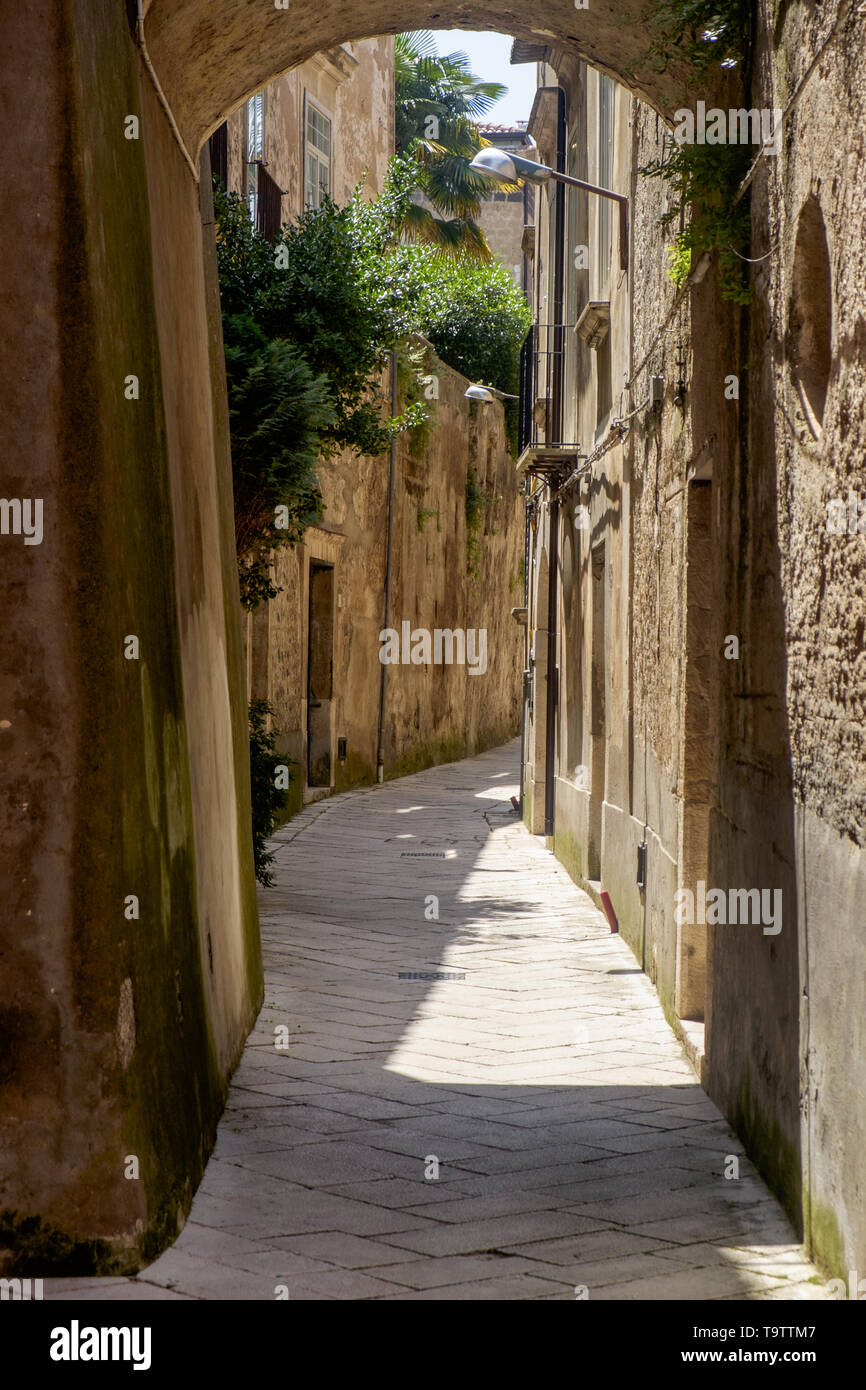 An abandoned alley in Sant'Agata de' Goti invites to walk in the silence. This village in Campania has an impressive Medieval center. Stock Photo