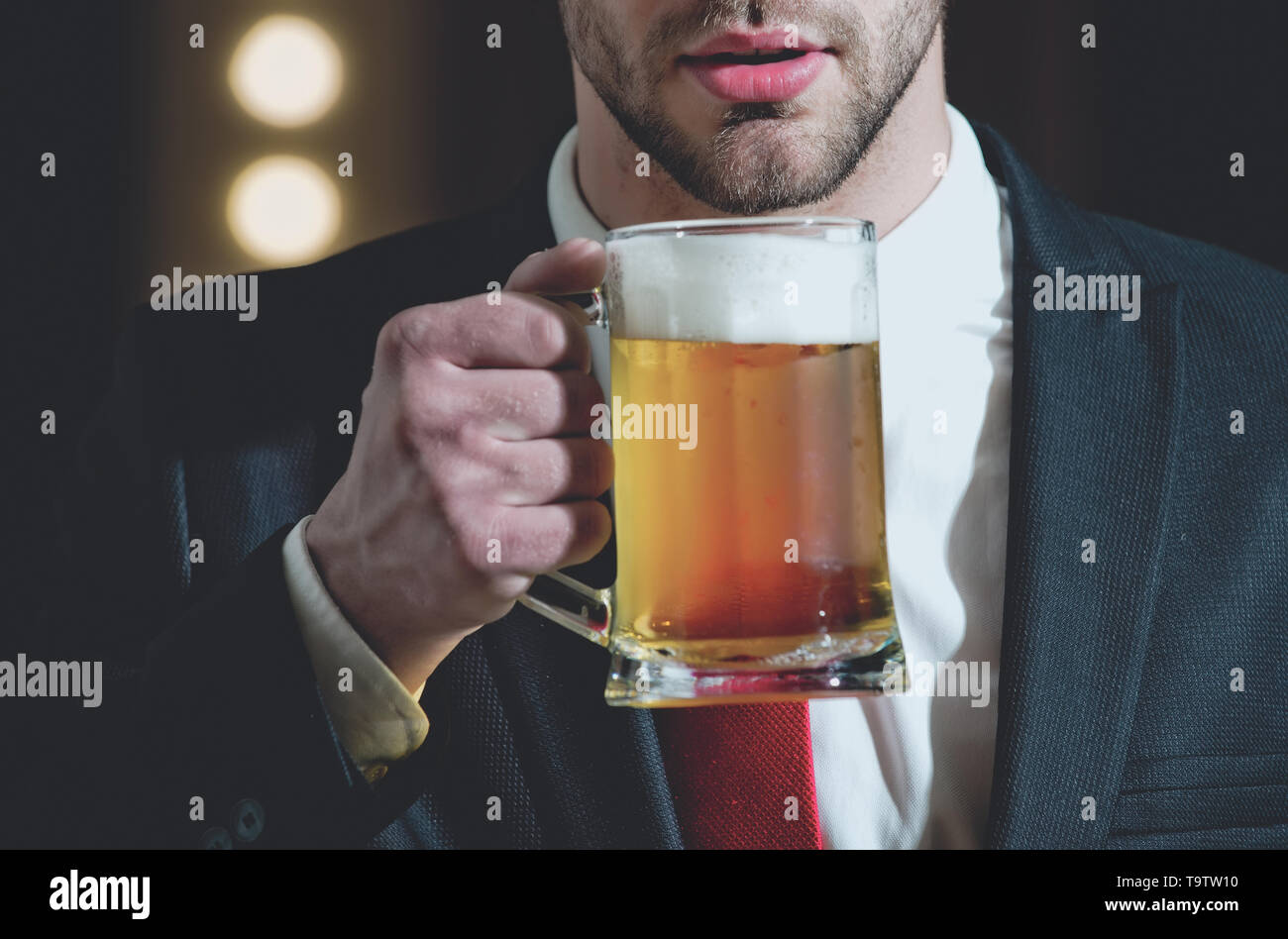 glass of beer in hand of sommelier man Stock Photo