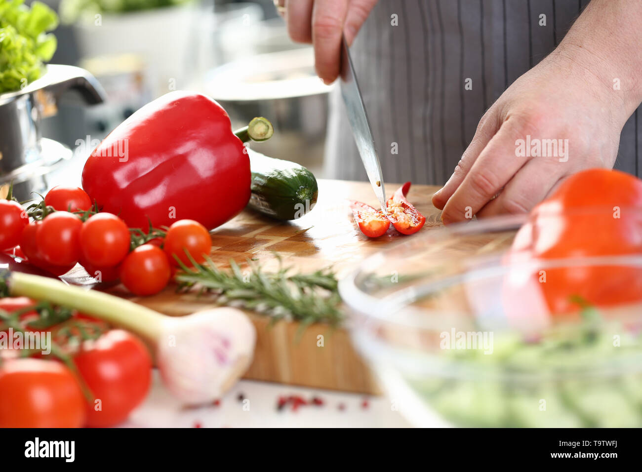 Chef Hands Cutting Red Hot Chili Pepper Halves Stock Photo