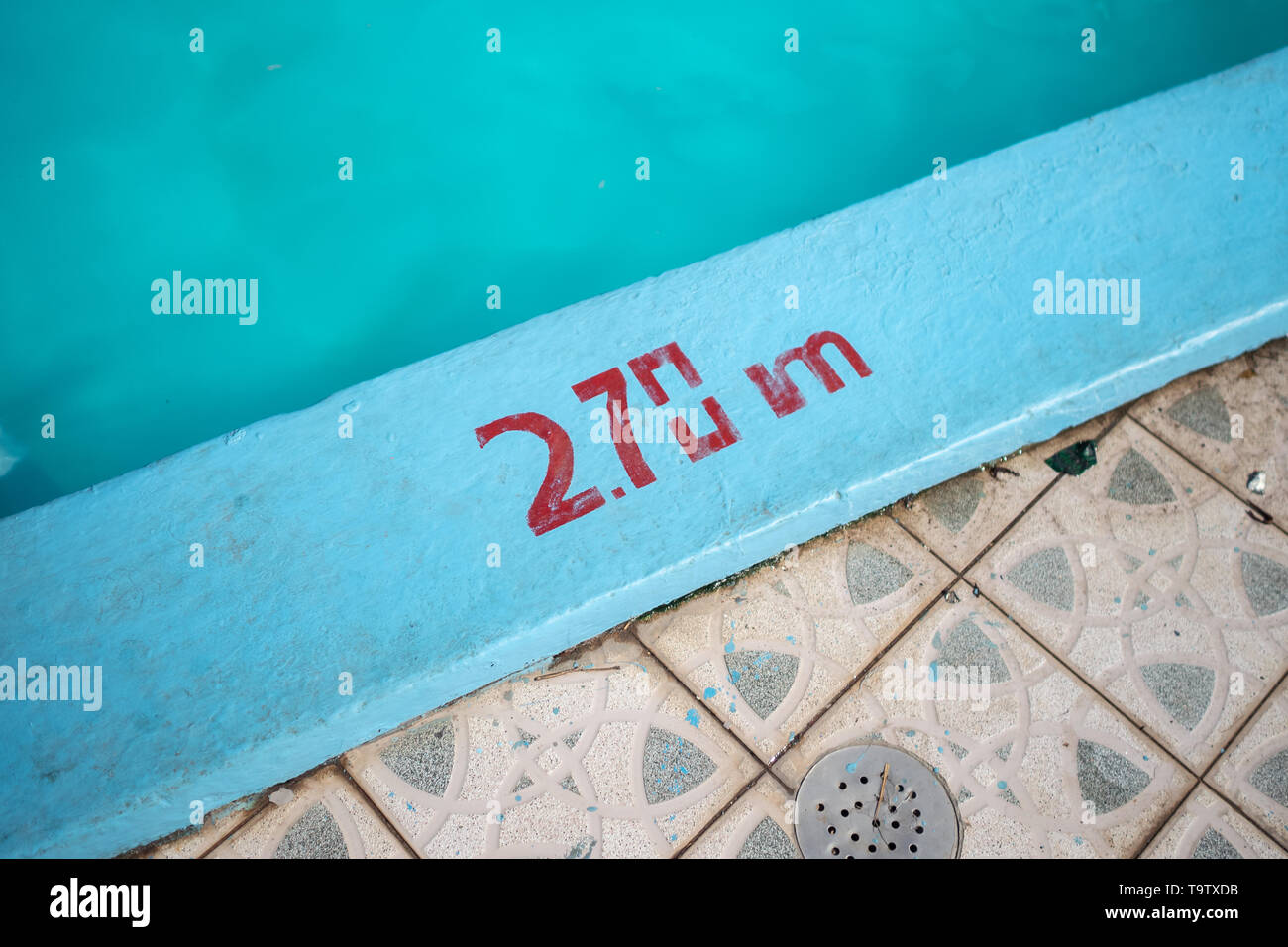2.70m depth marker painted in red on the side of a blue swimming pool Stock Photo