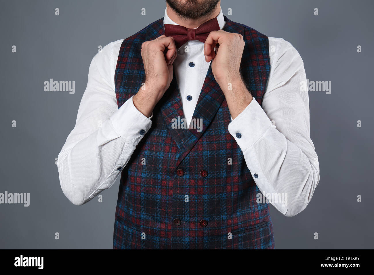 Fashionable young man in formal clothes on grey background Stock Photo