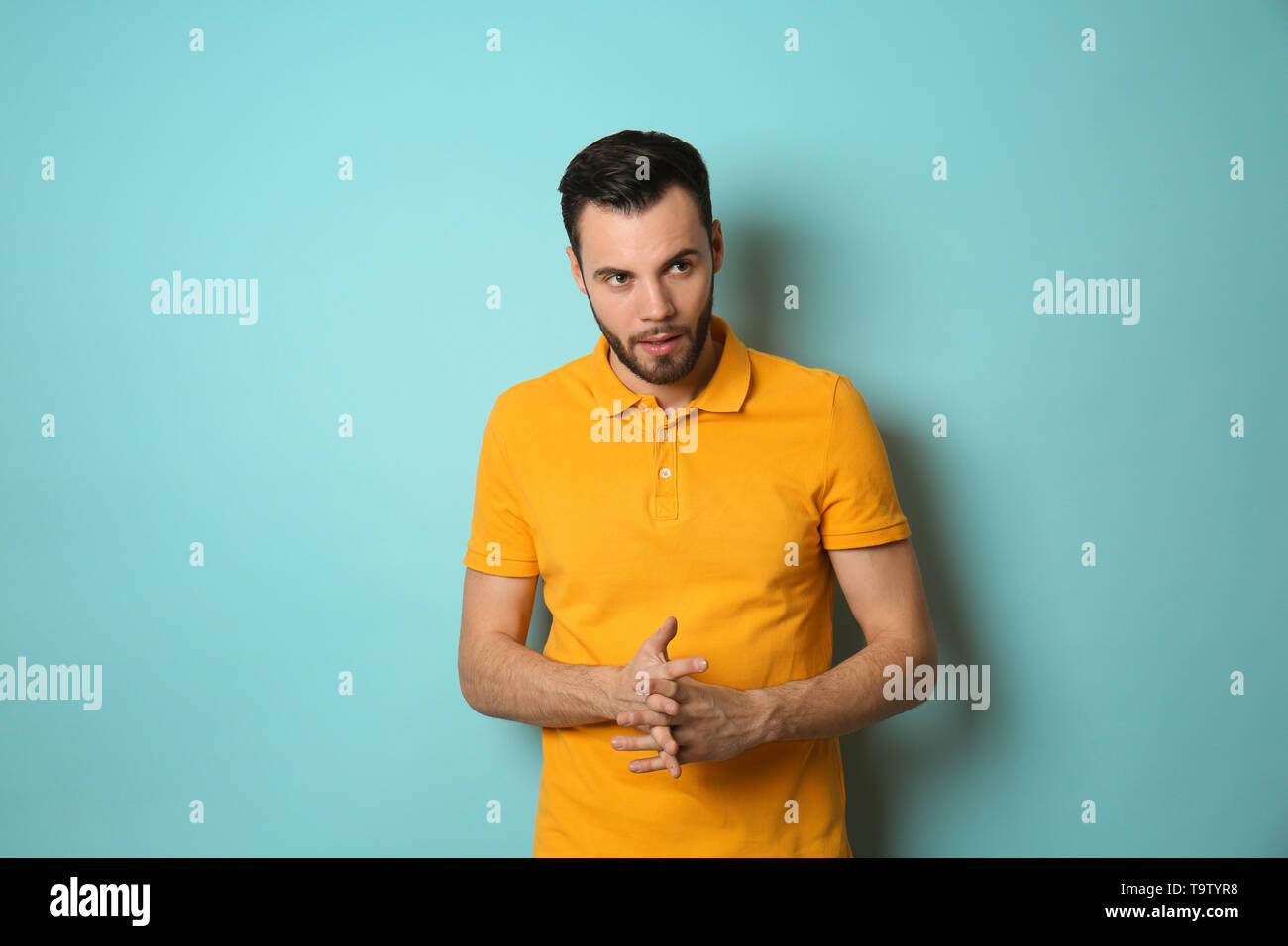 Fashionable young man on color background Stock Photo