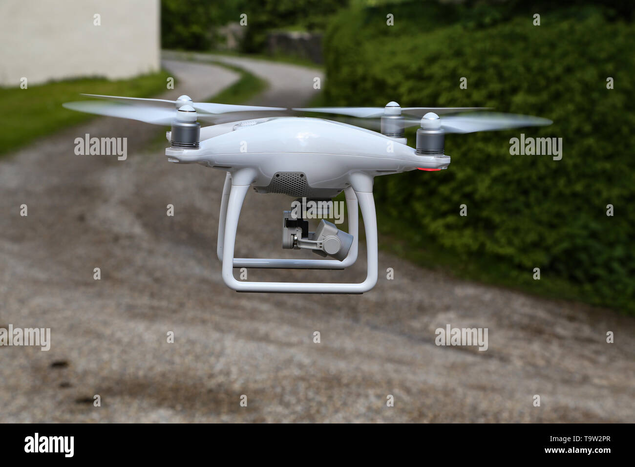Flying quadcopter with digital camera on blurred background. Stock Photo