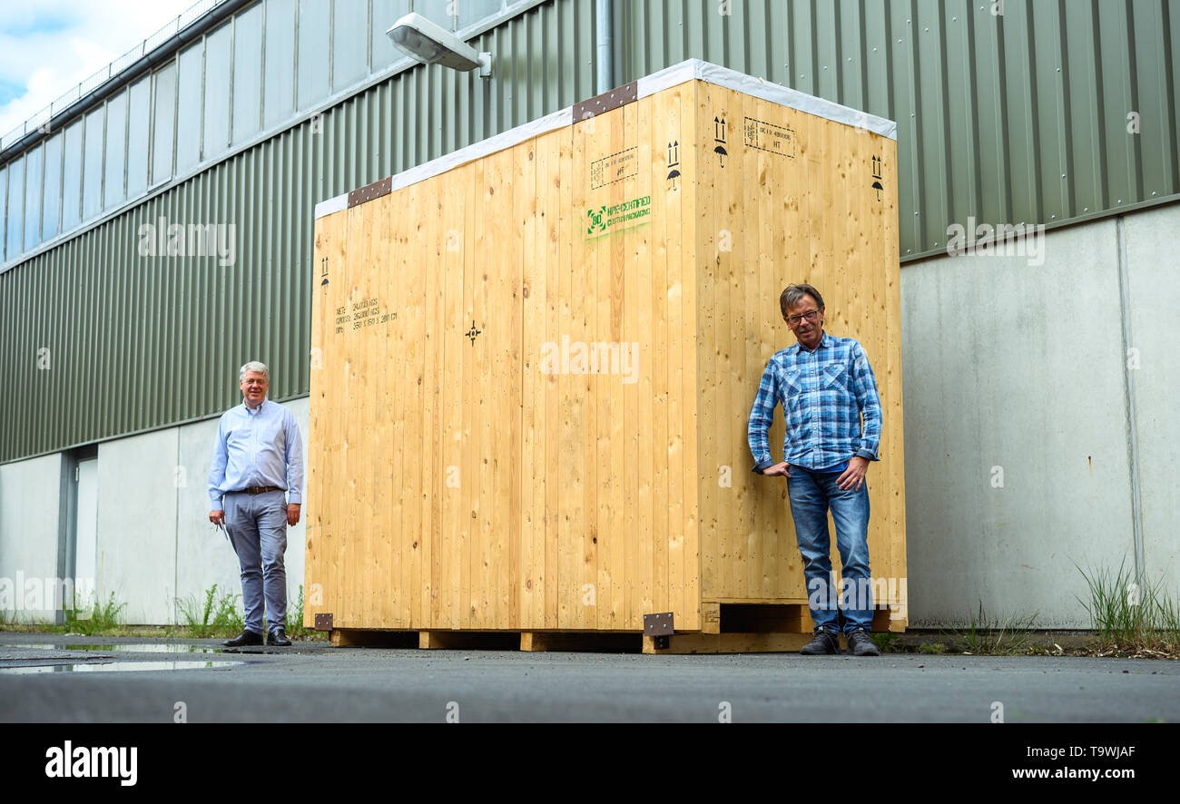 Bremen, Germany. 17th May, 2019. Markus Neumann (r), wood technician at the company 'Carl Gluud', and Jens Dörken, managing director of the company 'Carl Gluud', stand in front of one of their warehouses at an oversized wooden transport box. (to dpa 'Too big, too heavy? resourceful technicians get everything on the ship') Credit: Mohssen Assanimoghaddam/dpa/Alamy Live News Stock Photo