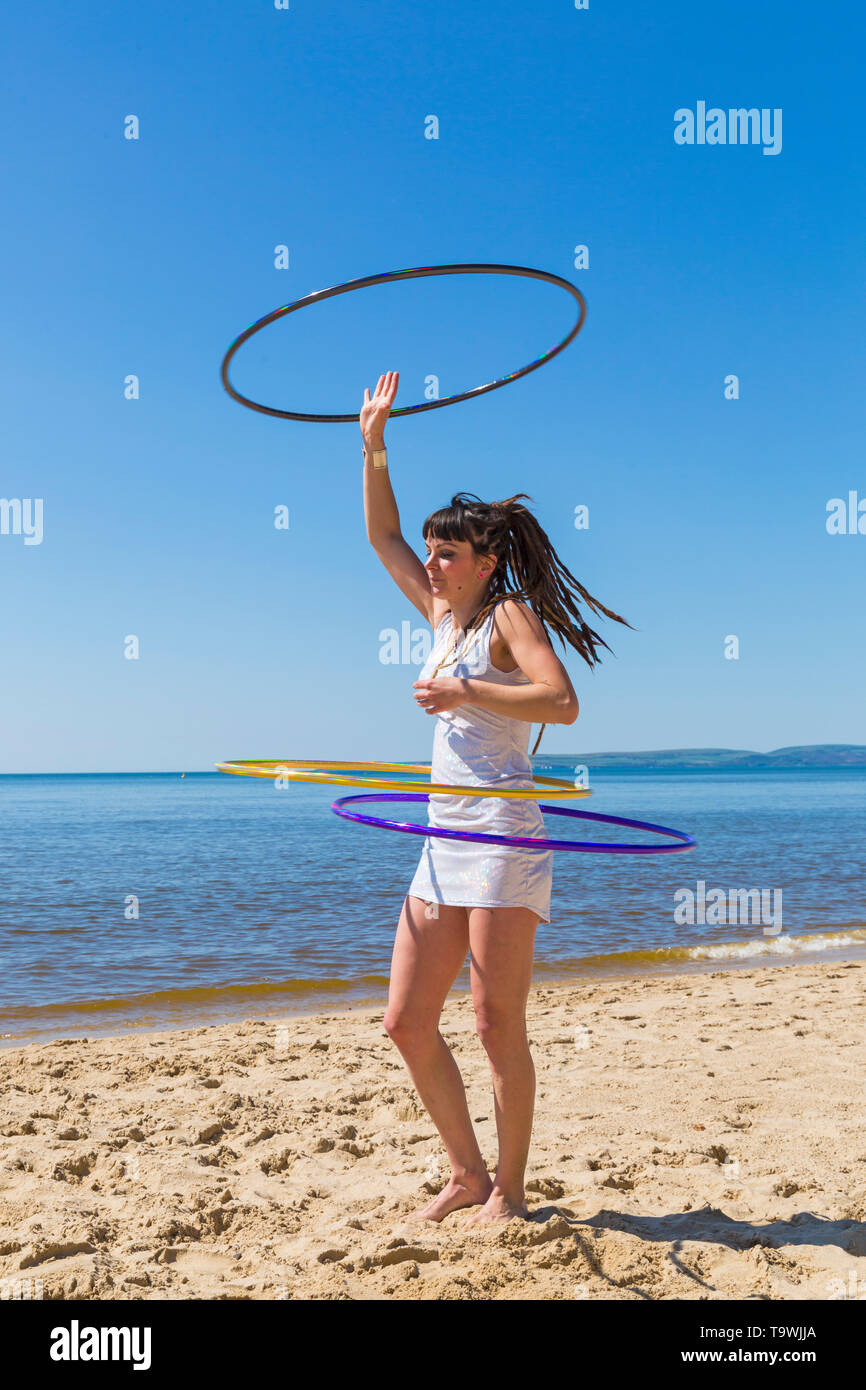 Southbourne, Bournemouth, Dorset, UK. 21st May, 2019. UK weather: lovely warm sunny morning as Lottie Lucid performs her hula hooping routine on the beach at Southbourne, enjoying the warm sunny weather in her mini dress. Credit: Carolyn Jenkins/Alamy Live News Stock Photo