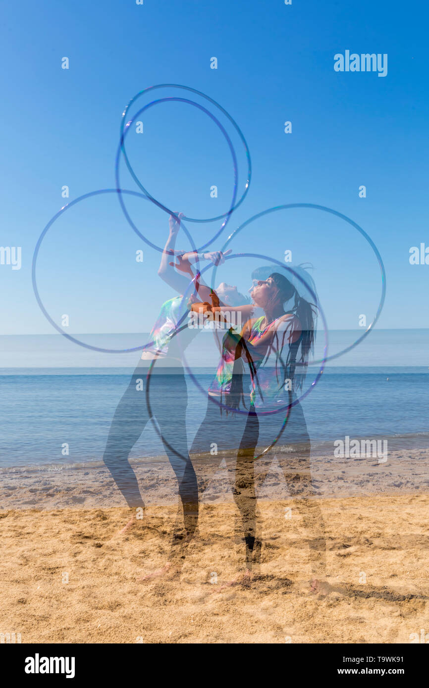 Southbourne, Bournemouth, Dorset, UK. 21st May 2019. UK weather: lovely warm sunny morning as Lottie Lucid performs her hula hooping routine on the beach at Southbourne, enjoying the warm sunny weather - multiple exposure. Credit: Carolyn Jenkins/Alamy Live News Stock Photo