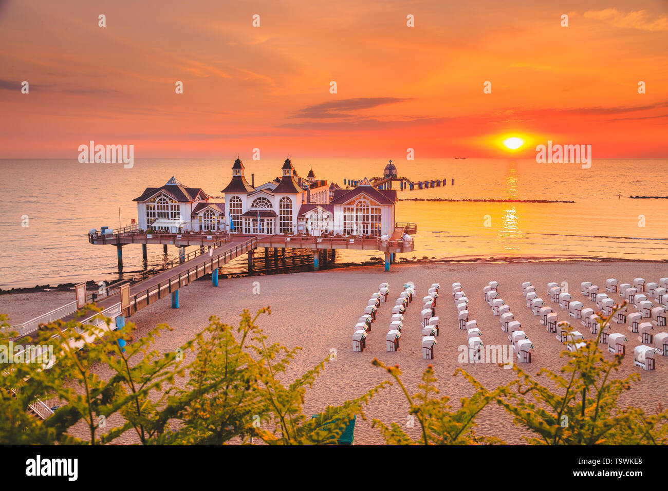 Famous Sellin Seebruecke (Sellin Pier) in beautiful golden morning light at sunrise in summer, Ostseebad Sellin tourist resort, Baltic Sea region, Ger Stock Photo