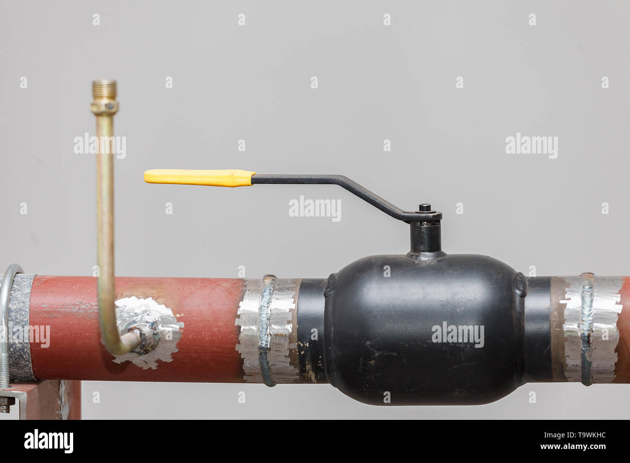 A heating system unit against a gray wall. Stock Photo