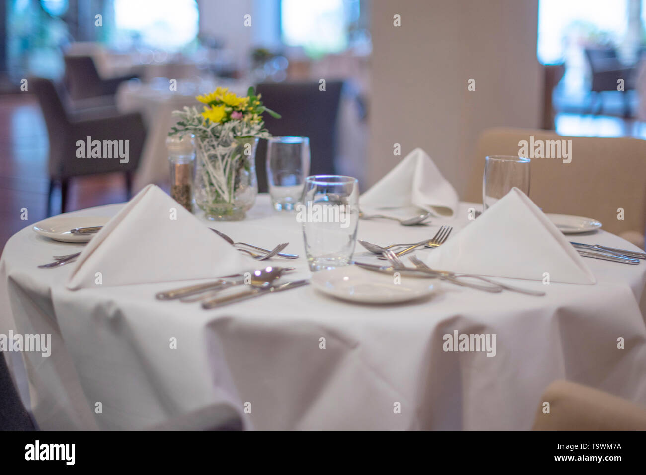 served table with a white tablecloth Stock Photo