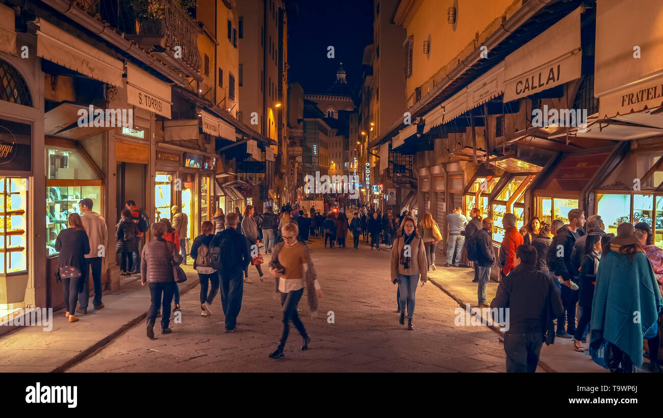 People on Florence, Italy City Street at Night Stock Photo