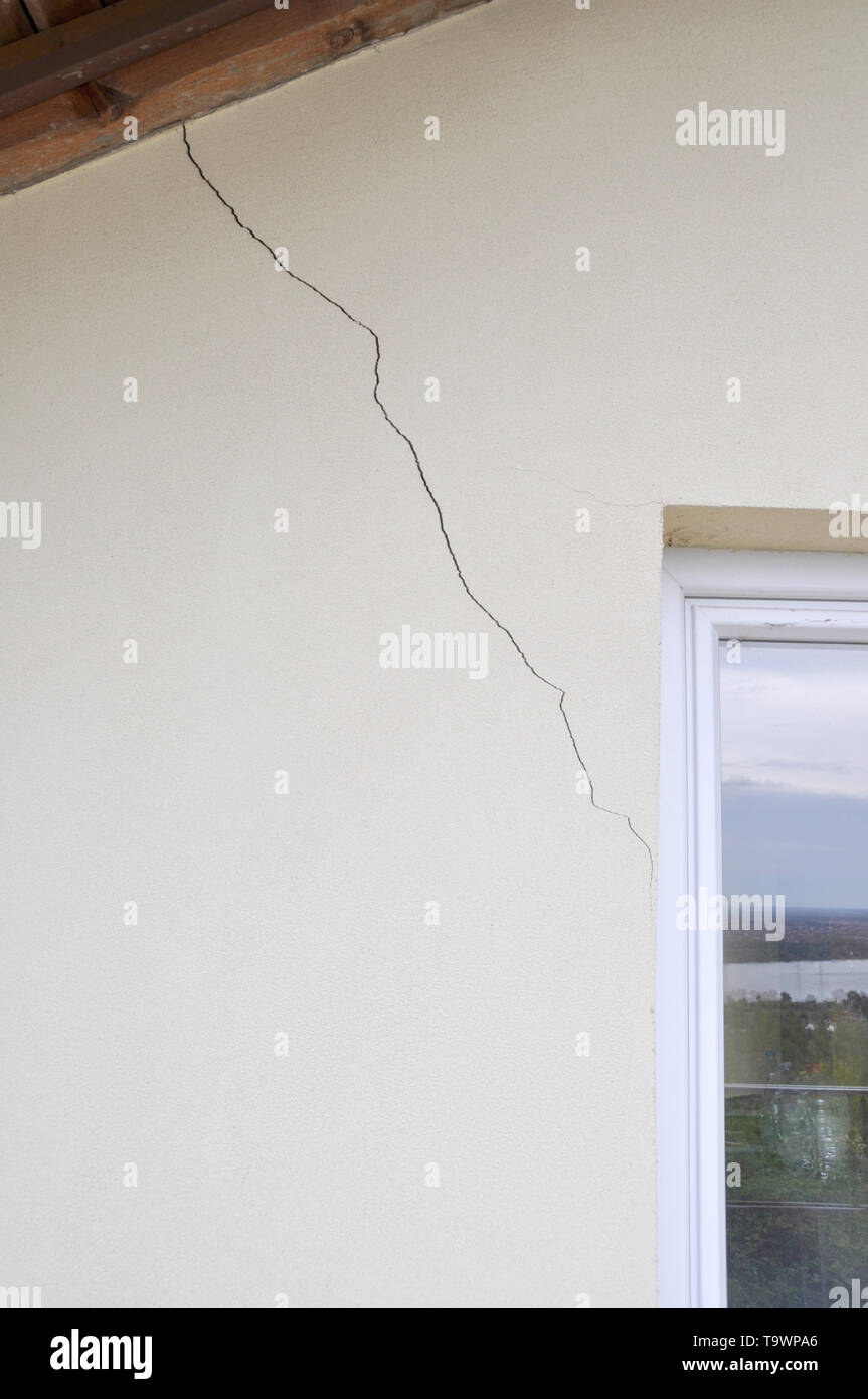 plaster wall with cracks. Building requiring repair .closeup Stock