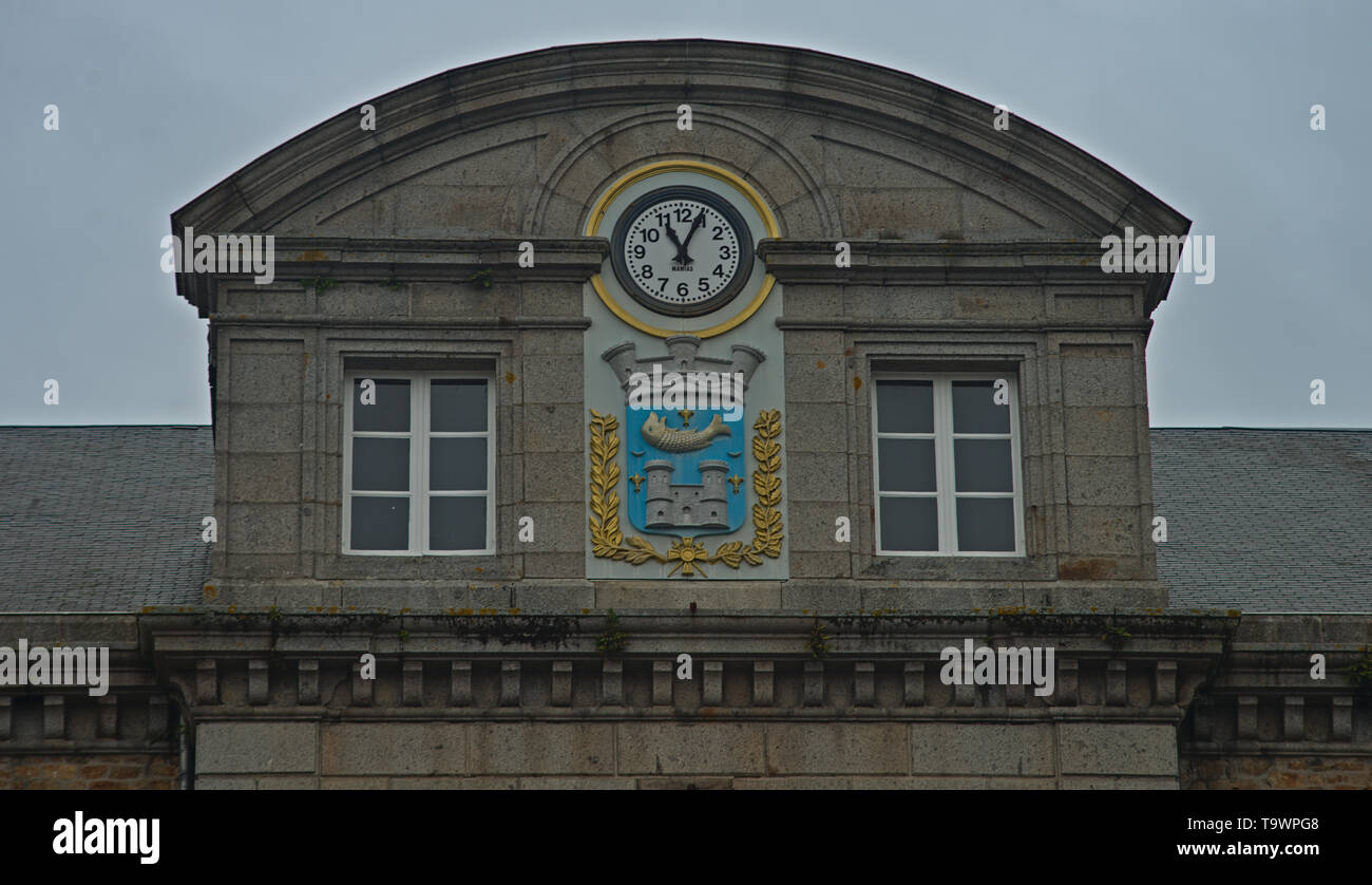 Domed building top with clock and coat of arms at Avranches, France Stock Photo