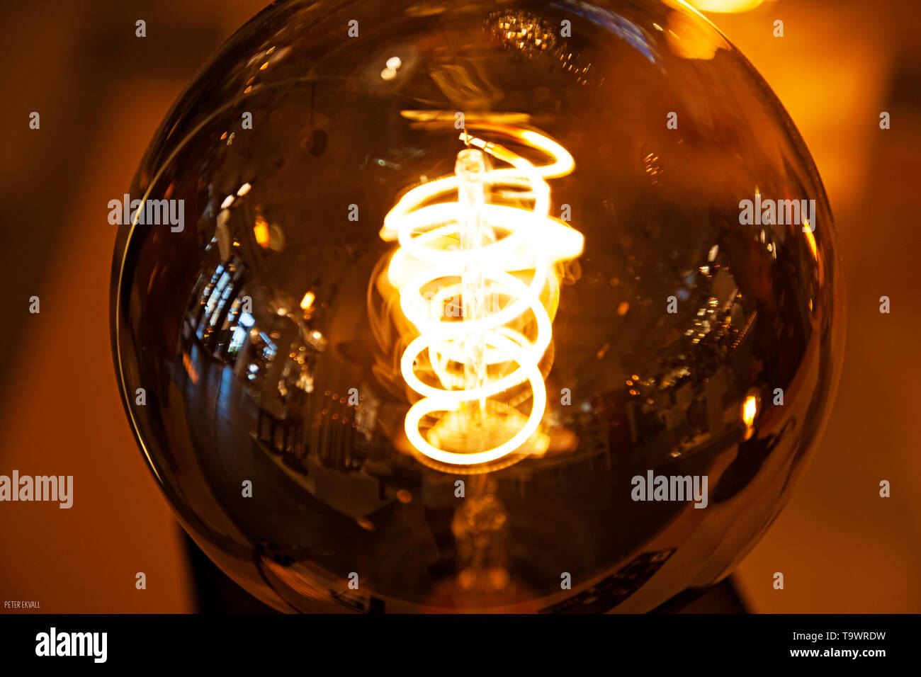 brown light bulb illuminating wire Stock Photo Alamy