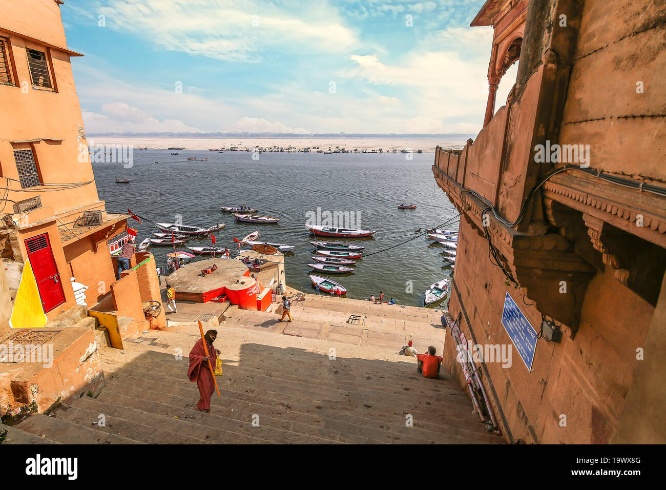 Varanasi Ganges river ghat with ancient architecture and long stairs leading down to the Ganga river bank. Stock Photo