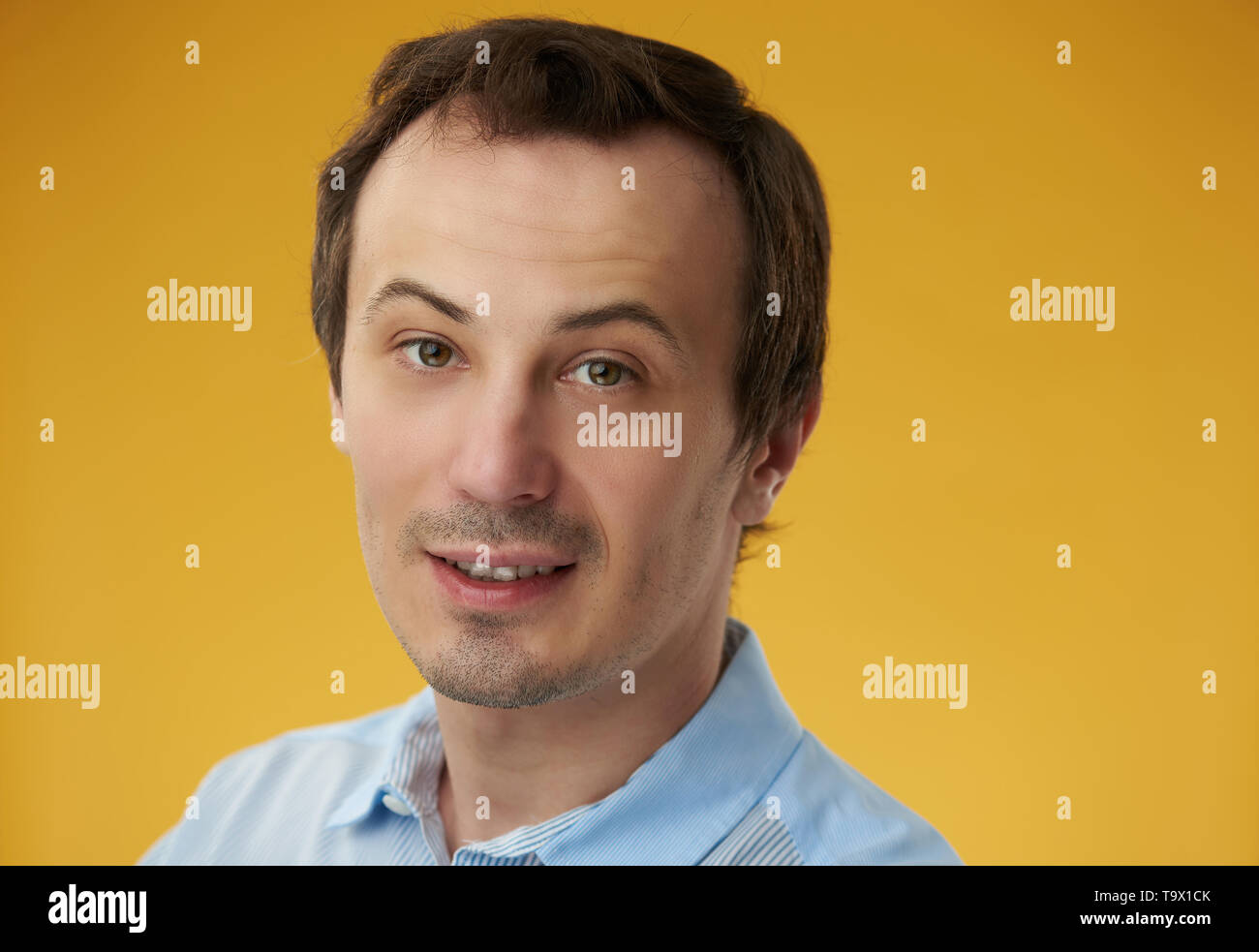 Russian white guy headshot smiling on yellow  color background Stock Photo