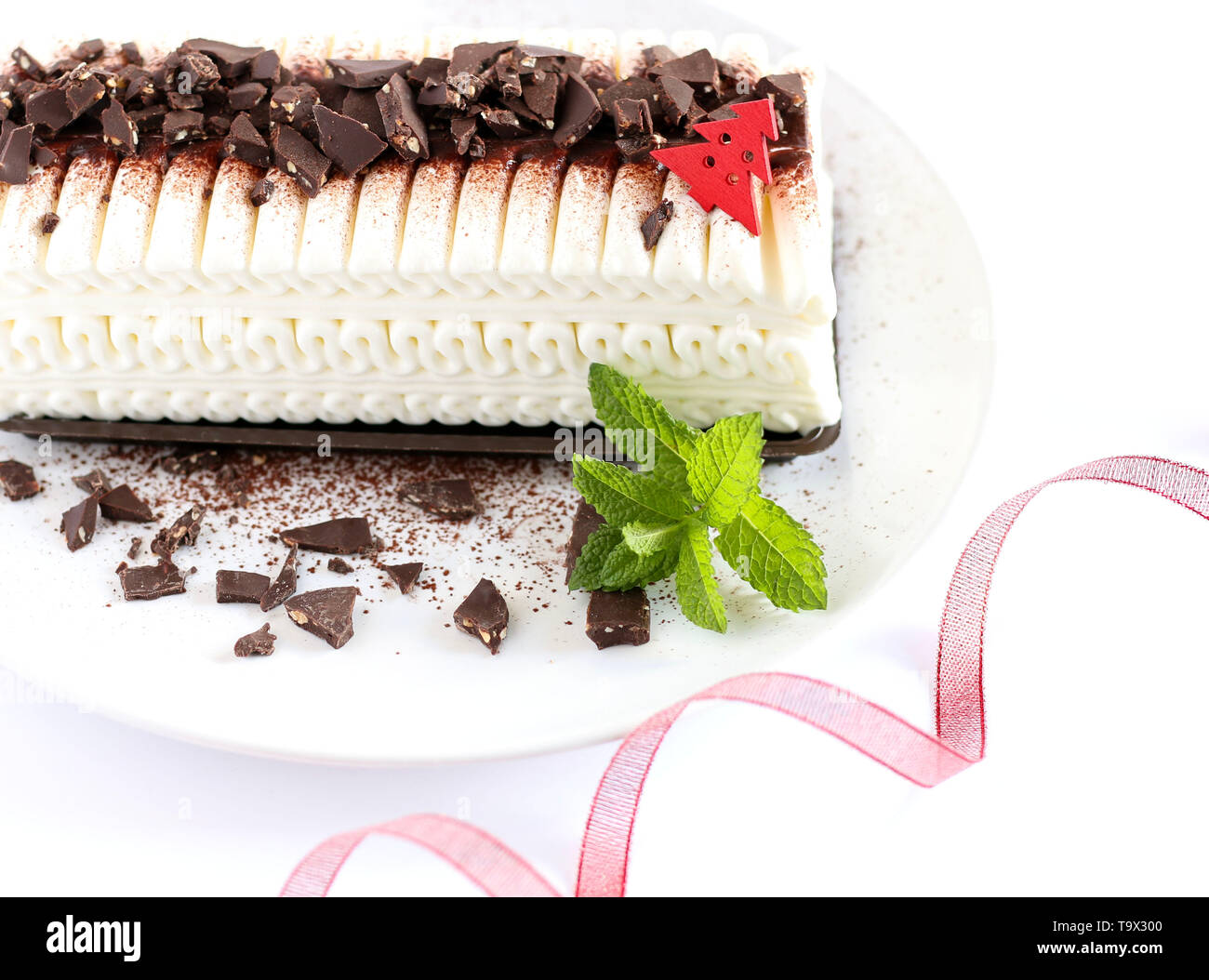 Christmas ice cream yule log cake with chocolate chips on a white